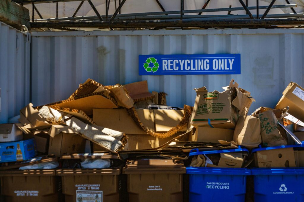 pexels-photo-12492301-12492301 Recycling area filled with cardboard and paper materials, promoting sustainability.
