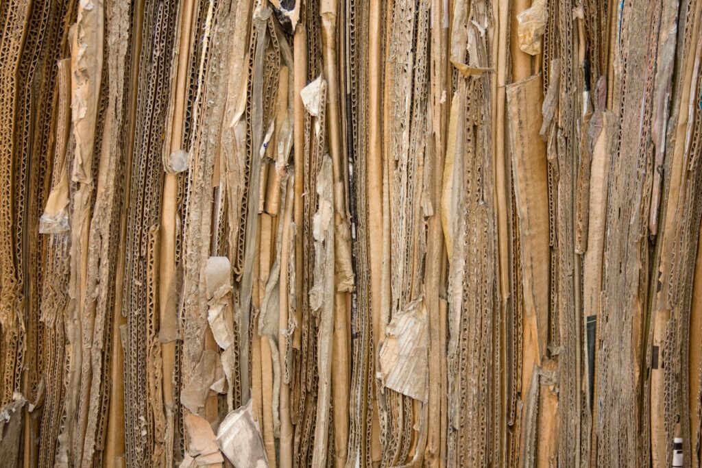 pexels-photo-4592995-4592995 Detailed view of stacked recyclable cardboard showing texture and patterns.